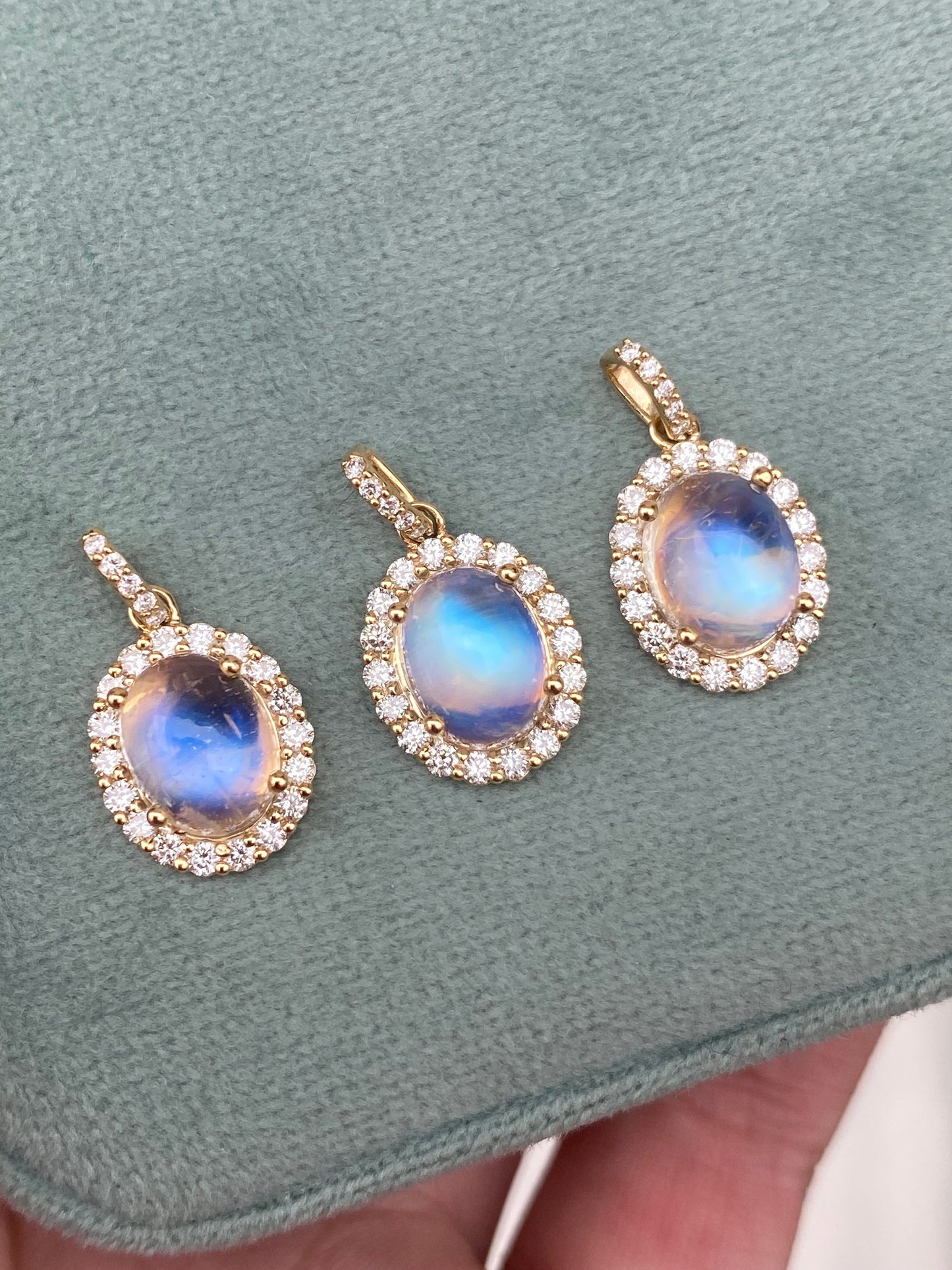 14kt moonstone cabochon with diamond halo bezel