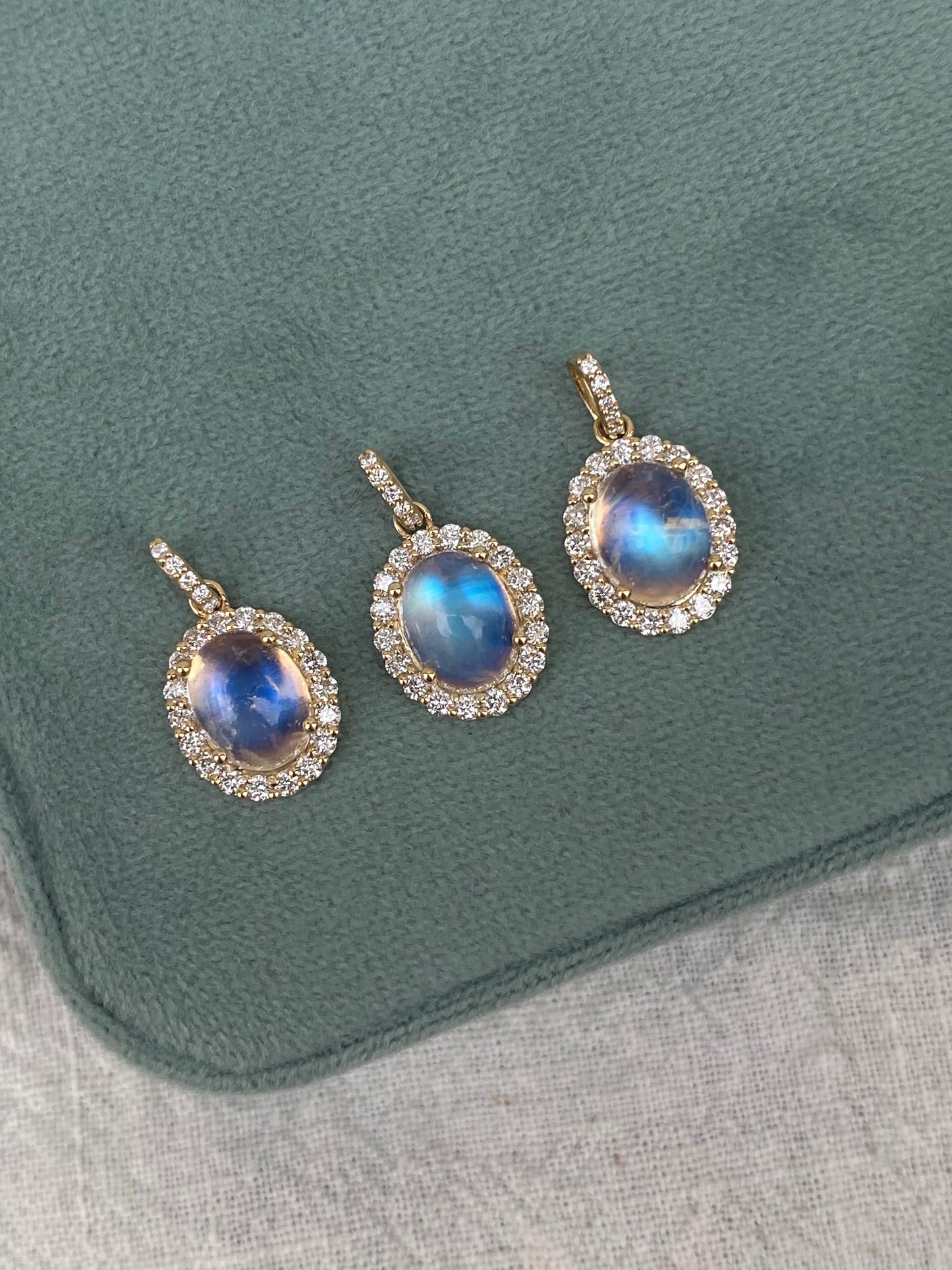 14kt moonstone cabochon with diamond halo bezel