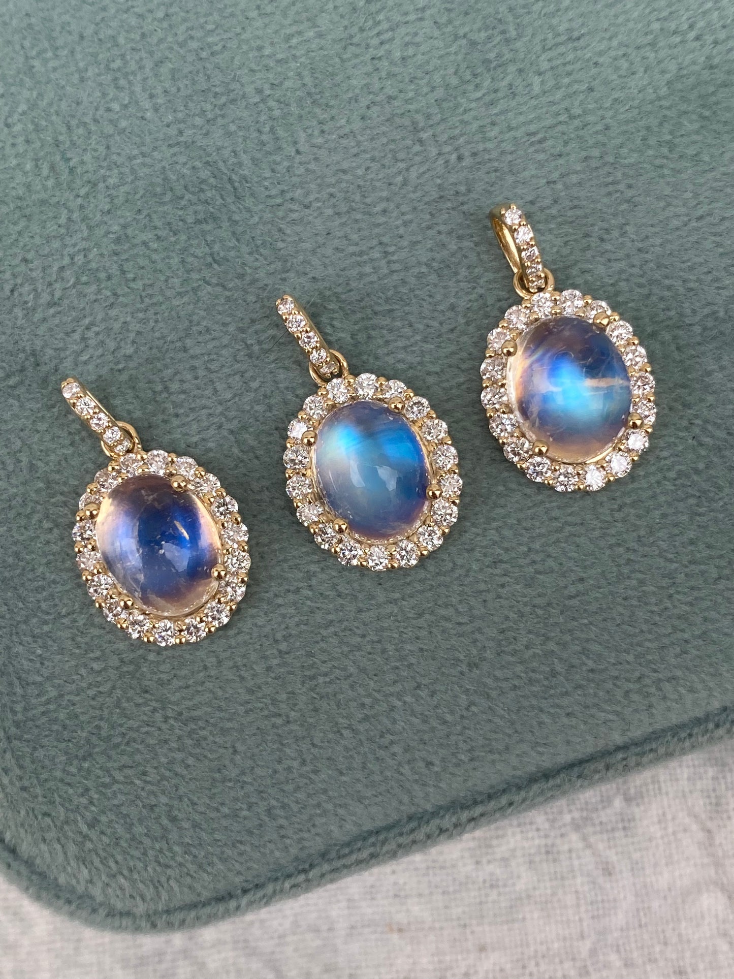 14kt moonstone cabochon with diamond halo bezel
