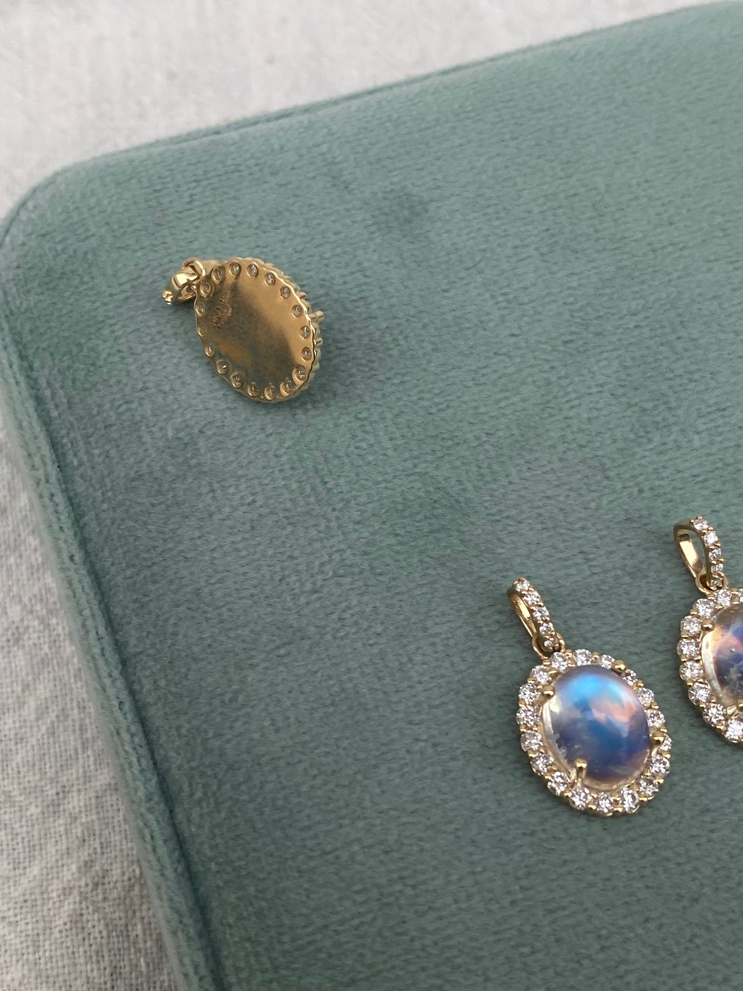 14kt moonstone cabochon with diamond halo bezel